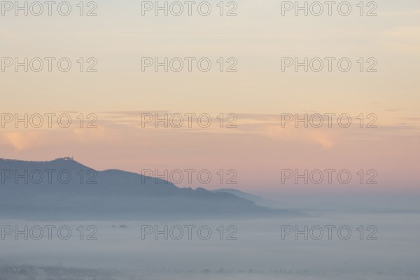 The majestic Teck Castle towers over the fog in the foothills of Alb. Aichelberg View of Teck Castle in a sea of fog