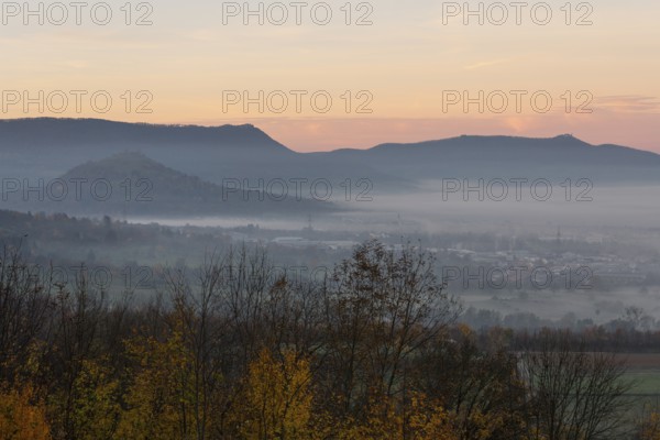 The majestic Teck Castle towers over the fog in the foothills of Alb. Aichelberg View of Teck Castle and Limburg in a sea of fog