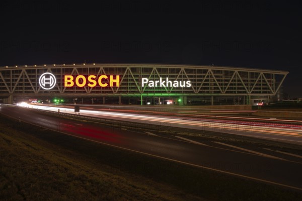 Night view of the A8 with traces of light at the P20 Messe car park, Airport, Stuttgart Germany
