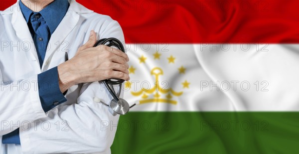 Tajikistan healthcare concept. Doctor with stethoscope on Tajikistan flag. Doctor holding stethoscope on Tajikistani flag