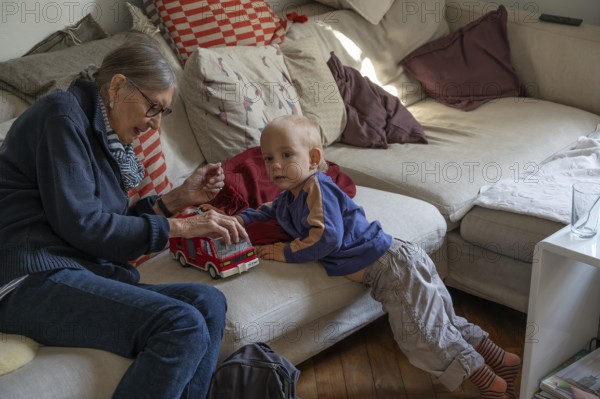 Great-grandmother playing with her great-grandson, two years old, Othenstorf, Mecklenburg-Western Pomerania, Germany