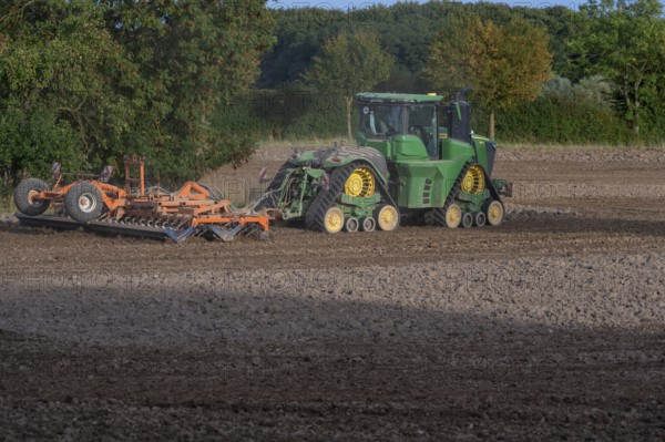 Crawler tractors harrow the field, Othenstorf, Mecklenburg-Western Pomerania, Germany