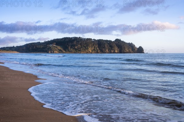 Landscape with sea and sandy beach in New Zealand. Hot Water Beach, Coromandel Peninsula, Waikato, New Zealand