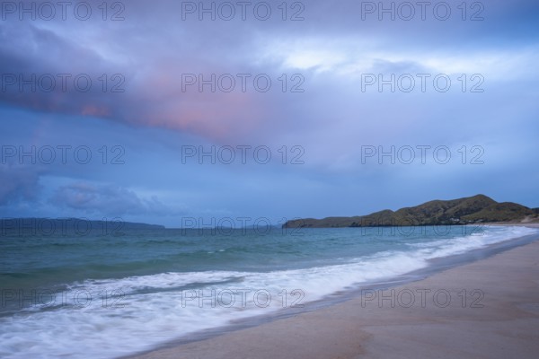 Landscape with sea and sandy beach in New Zealand in the evening at sunset. Otama Beach, Coromandel Peninsula, Waikato, New Zealand