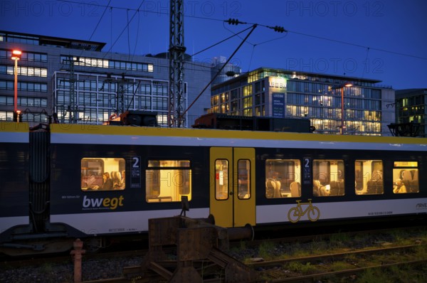 Incoming train, regional express, RE, bwegt, with bicycle compartment, in the background BW Bank, Baden-Wuerttembergische Bank, central railway station, blaue Stunde, Stuttgart, Baden-WÃ¼rttemberg, Germany
