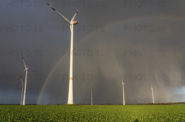 Königshovener Höhe onshore wind farm, on the A44 motorway near Bedburg, in front of the Jackerath triangle, autumn, rainbow, dark rain clouds, recultivated open-cast mining area, Garzweiler open-cast lignite mine, operated by RWE and the city of Bedburg, North Rhine-Westphalia, Germany