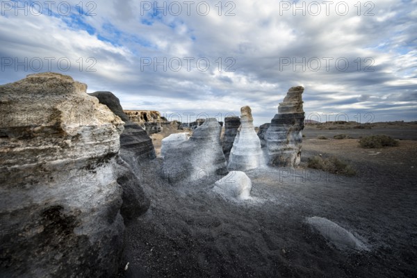 Eroded rock formations, volcanic landscape with dramatic cloudy skies, Ciudad Estratificada or Los Roferos, Antigua Rofera de Teseguite, Lanzarote, Canary Islands, Spain