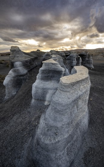Eroded rock formations, volcanic landscape with dramatic cloudy sky at sunset, Ciudad Estratificada or Los Roferos, Antigua Rofera de Teseguite, Lanzarote, Canary Islands, Spain