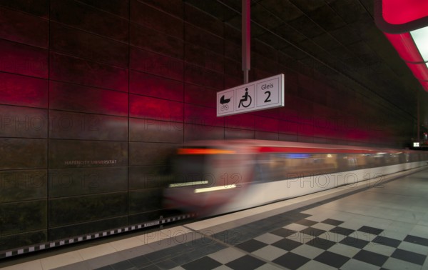 HafenCity University underground station, illuminated in color, red, underground train, movement effect, U4, empty, platform, stop, train station, subway, sign, boarding area wheelchair user, stroller, public transport, HVV, Hamburger Verkehrsverbund, Hochbahn, public transport, Free and Hanseatic City of Hamburg, Germany