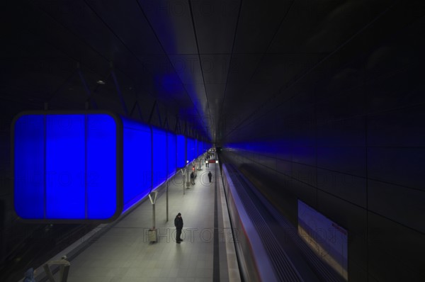 HafenCity University subway station, illuminated in color, blue, travelers, platform, stop, train station, subway, public transport, HVV, Hamburger Verkehrsverbund, Hochbahn, public transport, Free and Hanseatic City of Hamburg, Germany