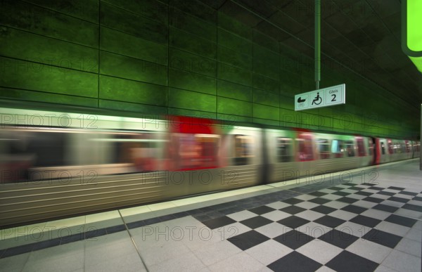 HafenCity University underground station, illuminated in color, green, underground train, movement effect, U4, platform, stop, train station, subway, sign, boarding area wheelchair user, stroller, public transport, HVV, Hamburger Verkehrsverbund, public transport, Freie und Hanseatic City of Hamburg, Germany