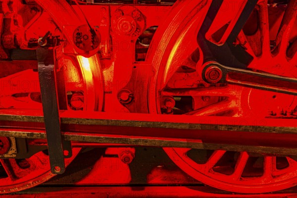 Illuminated wheelwork of a historic locomotive, railway museum, Augsburg railway park, administrative district of Swabia, Bavaria, Germany