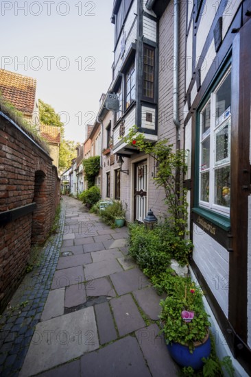 Colourful houses with shops and half-timbered houses in a small alley, picturesque district with nice little houses, Schnoor quarter in the morning light, Bremen, Germany