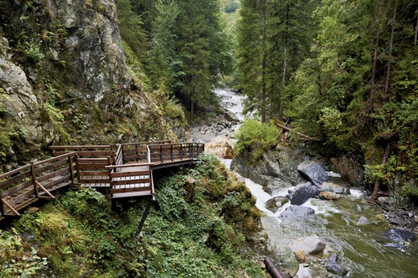 Wooden walkway on the Diosaz mountain river in the gorge, Gorges de la Diosaz, Les Houches, Chamonix-Mont-Blanc, Haute-Savoie, France