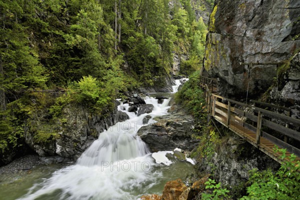 Wooden walkway next to the Diosaz mountain river in the gorge, Gorges de la Diosaz, Les Houches, Chamonix-Mont-Blanc, Haute-Savoie, France