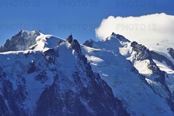 From left snow-covered Mont Blanc du Tacul, Aiguille du Midi, Mont-Blanc in the clouds, Chamonix-Mont-Blanc, Haute-Savoie, France