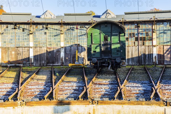 Historic railroad car parked in front of the old engine shed, Augsburg railway park, administrative district of Swabia, Bavaria, Germany