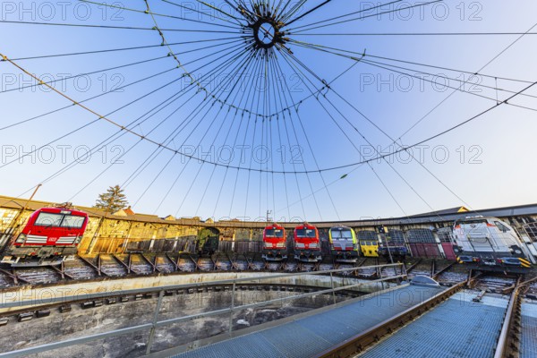 Turntable and overhead line spider, behind it modern locomotives of the Austrian Federal Railways, Ã–BB, and Deutsche Bahn, DB, parked in front of the old lock shed, Augsburg railway park, administrative district of Swabia, Bavaria, Germany