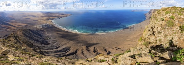 Panorama at Castillejo viewpoint, view from the Risco de Famara cliffs to the coast and the sea with Famara beach, Playa de Famara with La Calaeta, Lanzarote, Canary Islands, Spain