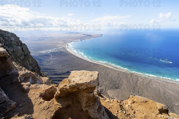 View from the Risco de Famara Cliff to Famara Beach, Playa de Famara with La Calaeta, Lanzarote, Canary Islands, Spain