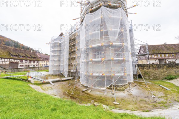 A rural-style renovated building with scaffolding and tarpaulins, surrounded by green spaces, Wasserschloss Glatt, Sulz, Germany