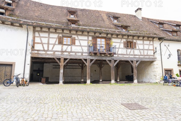 Historic courtyard with half-timbered balcony, paving stones, surrounded by traditional buildings, Glatt moated castle, Sulz, Germany