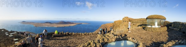 Stairway and tourists on the viewing platform at the Mirador del RÃ­o viewpoint, in the evening light, designed by artist César Manrique, Lanzarote, Canary Islands, Spain
