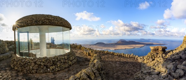 Stairway and viewing platform at the Mirador del RÃ­o viewpoint, in the evening light with sun stars, designed by artist César Manrique, view of the island of La Graciosa, Lanzarote, Canary Islands, Spain