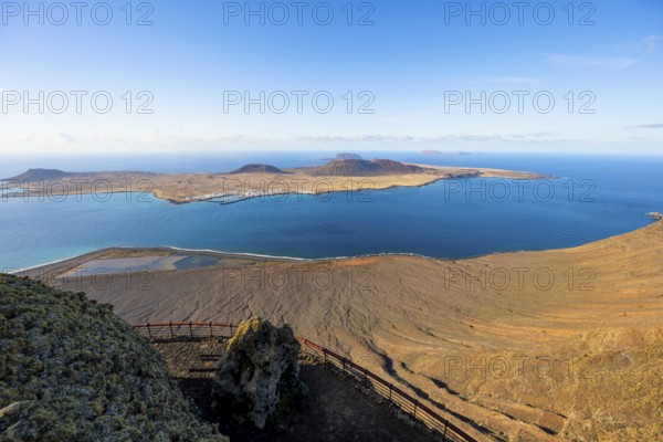 View of La Graciosa island with volcanic craters in the evening light, Mirador del RÃ­o viewpoint designed by artist CÃ©sar Manrique, Lanzarote, Canary Islands, Spain