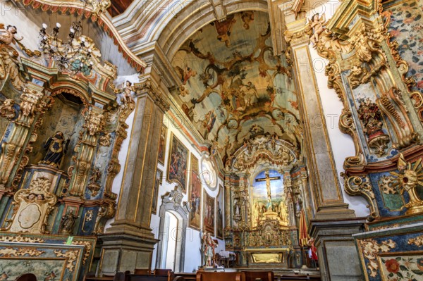 Baroque architecture of the historic Bom Jesus de Matosinhos church with Jesus crucified and religious symbols, Congonhas, Minas Gerais, Brazil