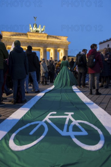 Athena Macke (costume designer) wears a dress with a long train in the shape of a bike path (bike path dress) at the international climate demo under the motto Fight for 1.5 at the Brandenburg Gate in Berlin on 14.11.2025. The demonstration takes place on the occasion of the COP30 World Climate Conference in Belém, Brazil, and to mark 10 years of the Paris Climate Agreement