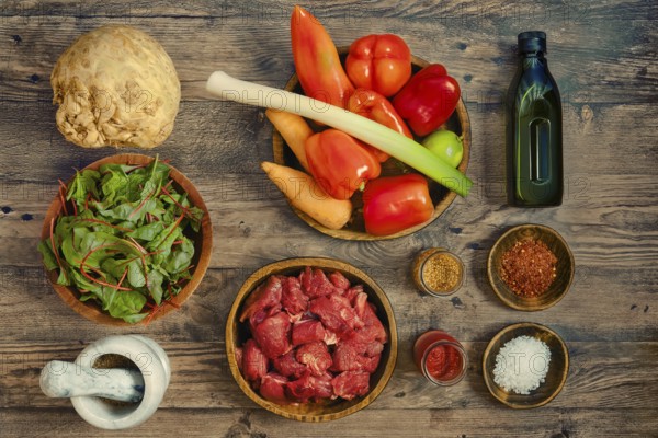 A vibrant assortment of fresh ingredients arranged on a wooden tabletop, illustrating healthy cooking or farm-to-table goods