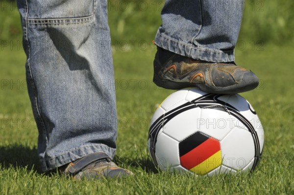 A boy's foot on a football, Germany
