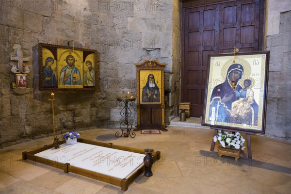 Religious icons and images in an atmospheric church room with burning candles, Bagrati Cathedral, Church of the Dormition of the Most Holy Mother of God, UNESCO World Heritage Site, Kutaisi, Imereti Region, Georgia