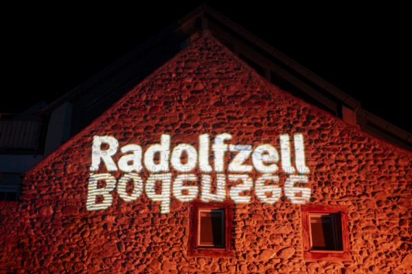 Projected lettering Radolfzell and Lake Constance, official logo of the city of Radolfzell on Lake Constance on a medieval stone house and city wall, as part of the Radolfzell Lichtblicke event and art campaign, supported by the Ministry of Labour, Economy and Tourism Baden-WÃ¼rttemberg, Konstanz district, Baden-WÃ¼rttemberg, Germany