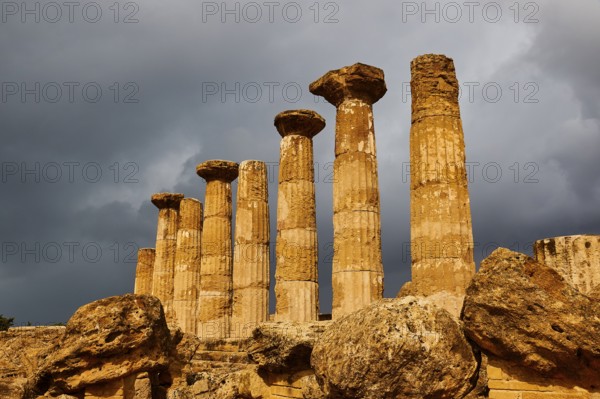 Temple of Heracles, ancient columns under dramatic stormy sky, Valley of the Temples, Valle dei Templi, Archaeological Site, UNESCO World Heritage Site, Agrigento, Sicily, Italy