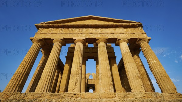 Temple of Concordia, imposing ancient temple with classical columns against a clear sky, Valley of the Temples, Valle dei Templi, Archaeological Site, UNESCO World Heritage Site, Agrigento, Sicily, Italy