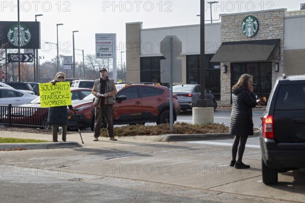 Detroit, Michigan USA - 15 November 2025 - People picket a Starbucks store in solidarity with a strike going on at the company's unionized stores. The picketers asked would-be customers to get their coffee elsewhere