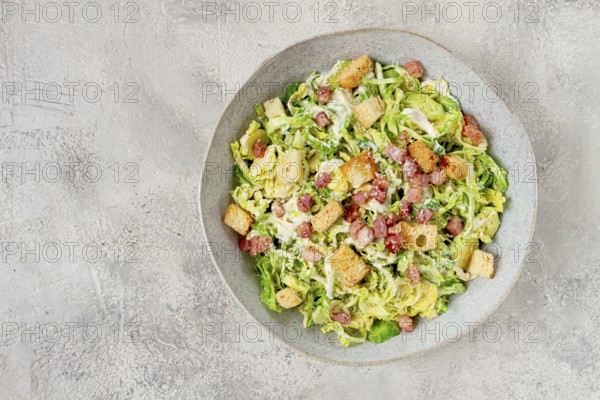 Brussels sprouts Caesar salad, with bacon and croutons, healthy food, homemade, no people