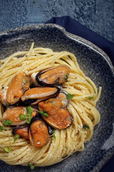 Spaghetti with mussels, without shell, pasta with peeled mussels, in carbonara sauce, micro-greens, homemade, no people