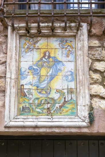 Historic ceramic tiles religious image above doorway, medieval village of AlbarracÃ­n, Teruel province, Aragon, Spain
