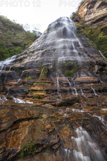 Leura Falls in a lush valley full of ferns and vegetation, Blue Mountains, New South Wales, Australia