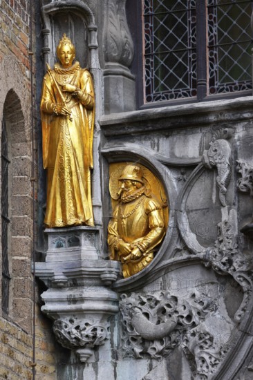 Golden figures on the faÃ§ade of the St. Ivo Chapel at the Basilica of the Holy Blood, Castle Square in the historic old town, Bruges, UNESCO World Heritage Site, Flanders, Belgium