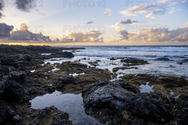 Seaside coast with volcanic rocks at sunset, La Santa, Lanzarote, Canary Islands, Spain