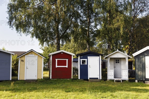 Different colored beach huts in a meadow, Ystad, Sweden