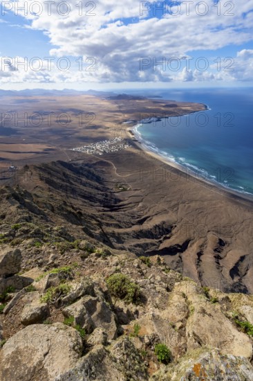 Castillejo viewpoint, view from the Risco de Famara cliffs to the coast and the sea with the Famara beach, Playa de Famara, Lanzarote, Canary Islands, Spain