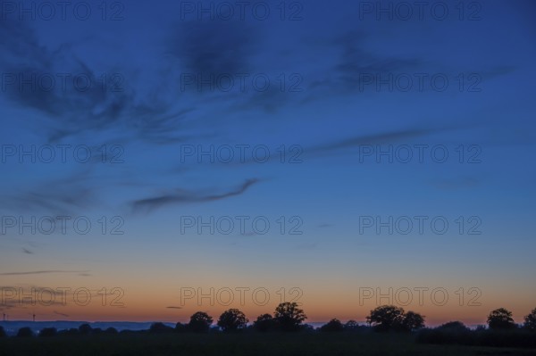 Landscape silhÃ¶tte in the blue red evening sky, Mecklenburg-Western Pomerania, Germany