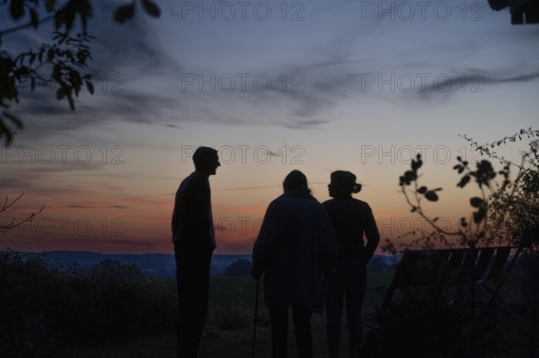 Three people as a silhötte in the evening backlight, Mecklenburg-Western Pomerania, Germany