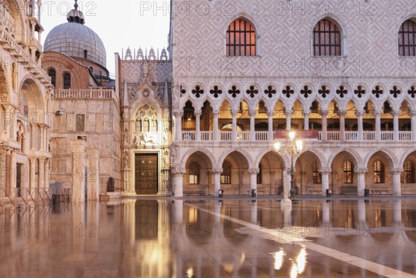 Before sunrise, Doge's Palace and Porta della Carta, during Aqcua Alta, Venice, Italy