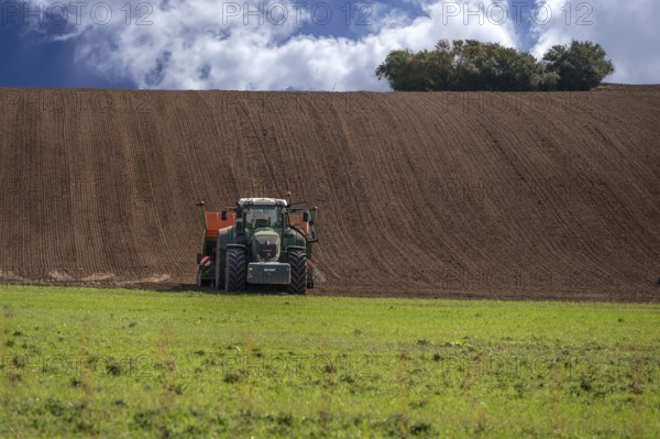 Farmer cultivates his field with a large tractor, Mecklenburg-Vorpommern, Germany